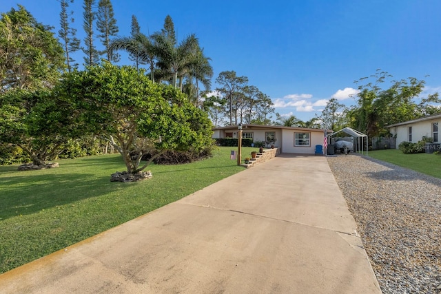 view of front of house with a front lawn and a carport