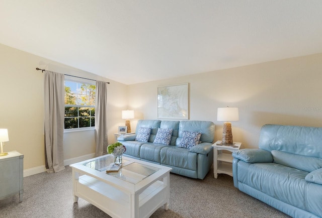 carpeted living room featuring lofted ceiling