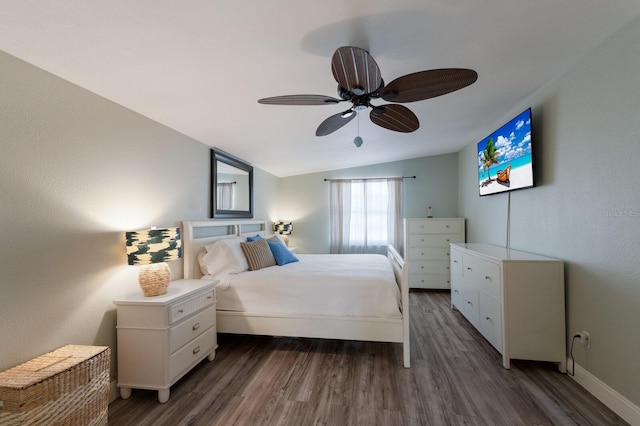 bedroom with ceiling fan, dark hardwood / wood-style floors, and lofted ceiling