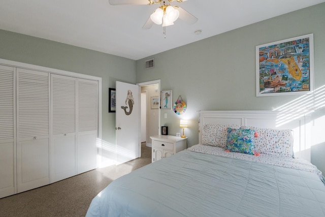 carpeted bedroom featuring ceiling fan and a closet