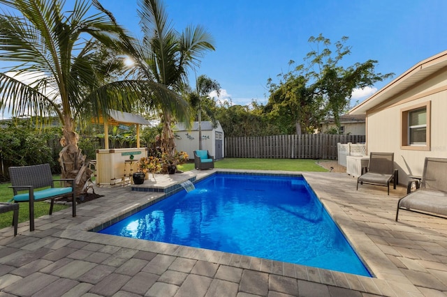 view of pool featuring a storage unit and a patio area