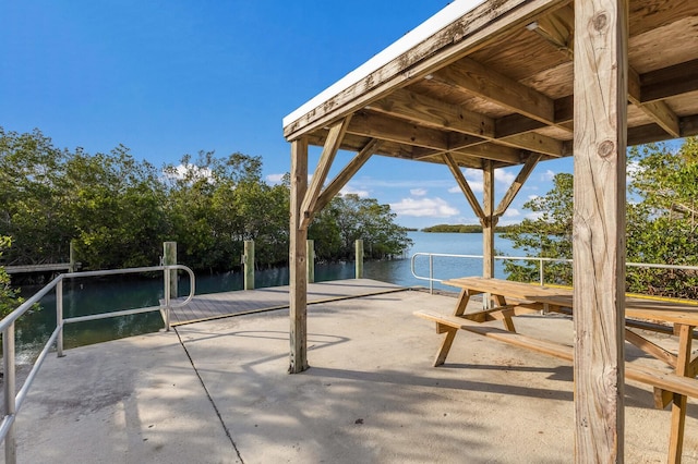 view of patio / terrace with a dock and a water view