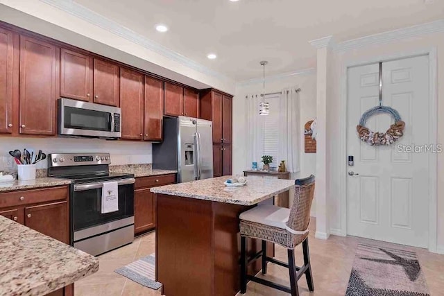 kitchen with pendant lighting, a center island, stainless steel appliances, and ornamental molding