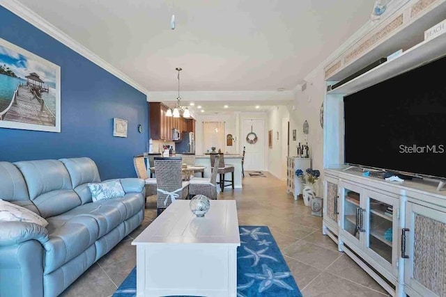 tiled living room featuring ornamental molding and a notable chandelier