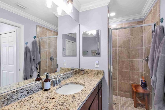 bathroom with vanity, an enclosed shower, and ornamental molding