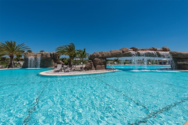 view of swimming pool featuring pool water feature