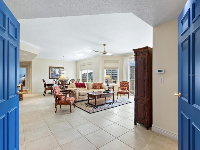 tiled living room featuring ceiling fan, crown molding, and a textured ceiling