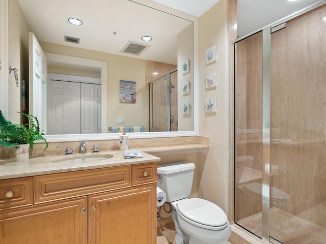 bathroom featuring vanity, toilet, and an enclosed shower