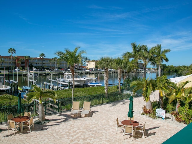 view of patio / terrace featuring a boat dock and a water view