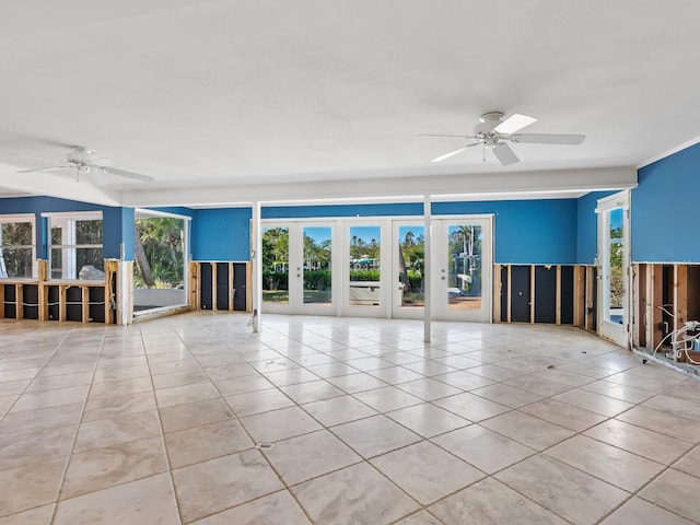 unfurnished living room with ceiling fan, french doors, and light tile patterned floors