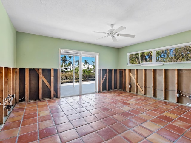 tiled spare room featuring ceiling fan and a textured ceiling