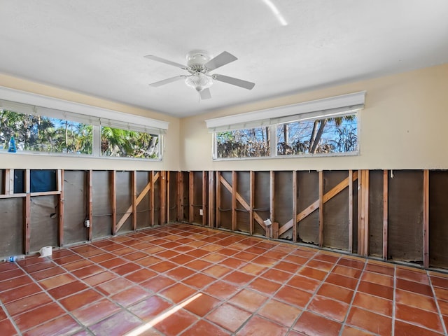 misc room with tile patterned flooring and ceiling fan