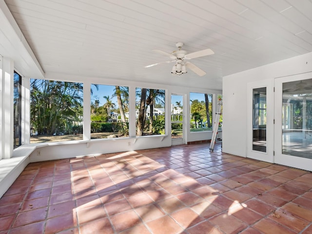 unfurnished sunroom featuring ceiling fan