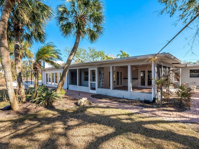 rear view of property with a yard and french doors