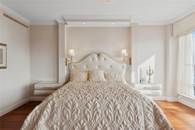 bedroom with wood-type flooring, multiple windows, and crown molding