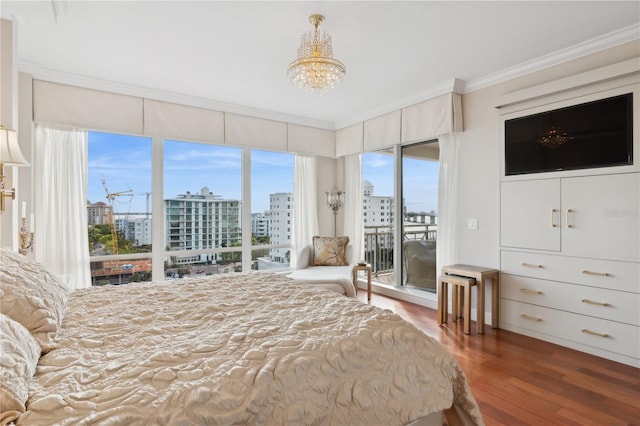 bedroom featuring access to exterior, crown molding, dark wood-type flooring, and an inviting chandelier