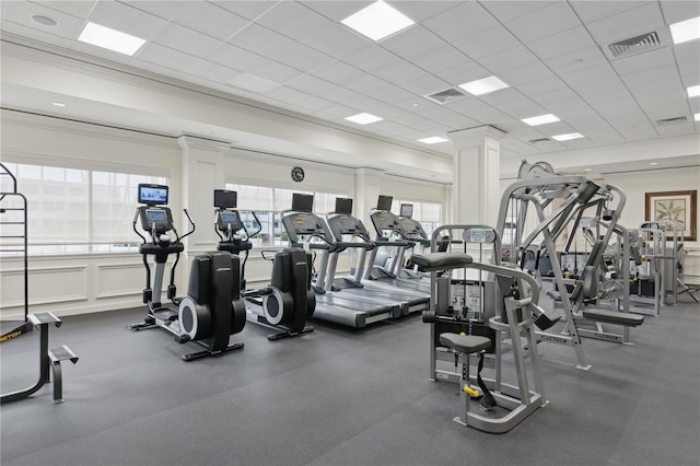 exercise room featuring a drop ceiling and ornamental molding