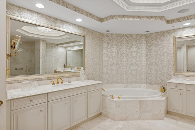 bathroom featuring a raised ceiling, tile patterned floors, tiled bath, vanity, and ornamental molding