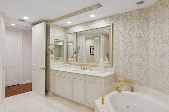 bathroom with a tub to relax in, vanity, and wood-type flooring