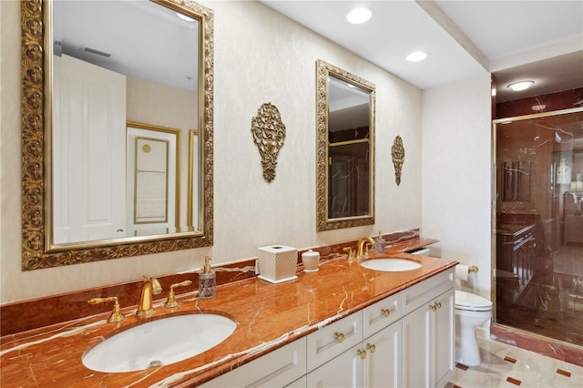 bathroom with tile patterned flooring, vanity, toilet, and an enclosed shower