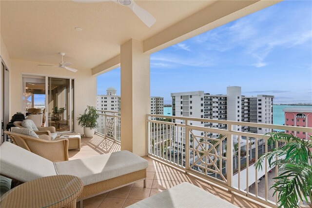 balcony featuring ceiling fan and a water view