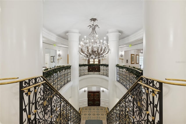 staircase featuring ornamental molding and a notable chandelier