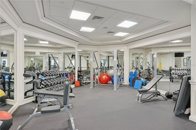 exercise room with a paneled ceiling and crown molding