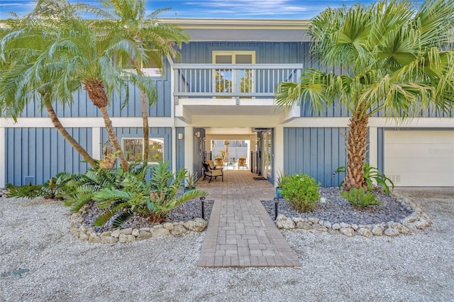 exterior space with a garage and a balcony