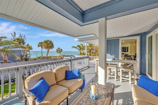 view of patio / terrace featuring outdoor lounge area, a balcony, and a water view