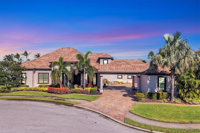 mediterranean / spanish-style house with a yard