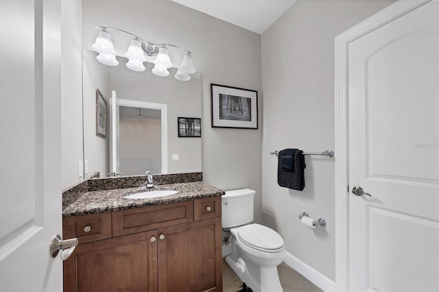 bathroom with tile patterned floors, vanity, and toilet