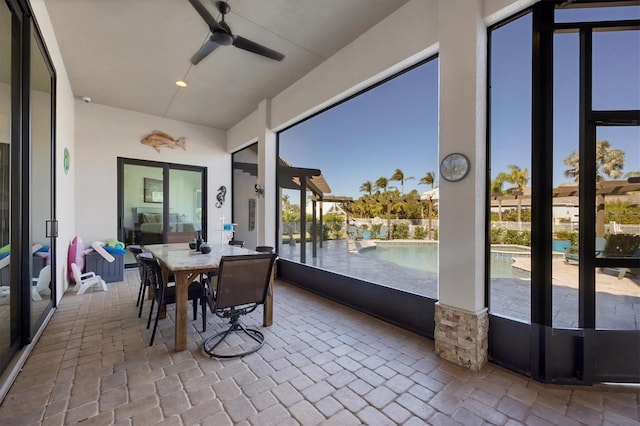 sunroom / solarium with ceiling fan