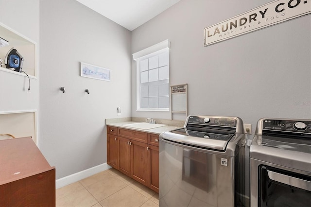 clothes washing area featuring light tile patterned flooring, independent washer and dryer, cabinets, and sink