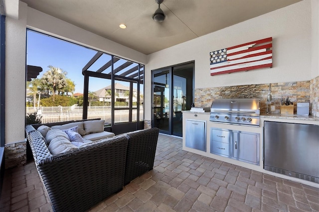 view of patio featuring an outdoor living space, an outdoor kitchen, and grilling area