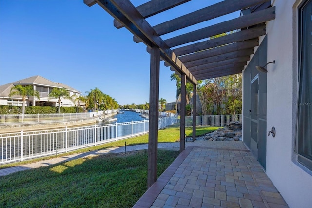 view of patio / terrace with a pergola and a water view