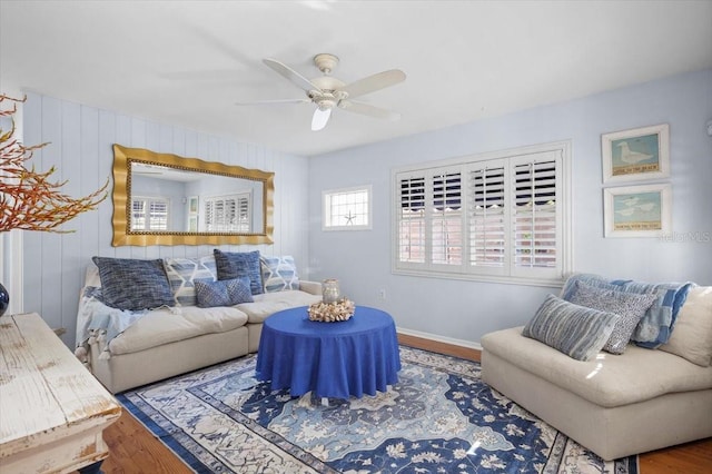 living room featuring ceiling fan and hardwood / wood-style floors