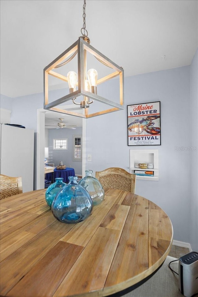 dining room featuring ceiling fan with notable chandelier