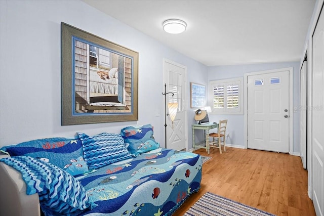 bedroom featuring lofted ceiling and wood-type flooring