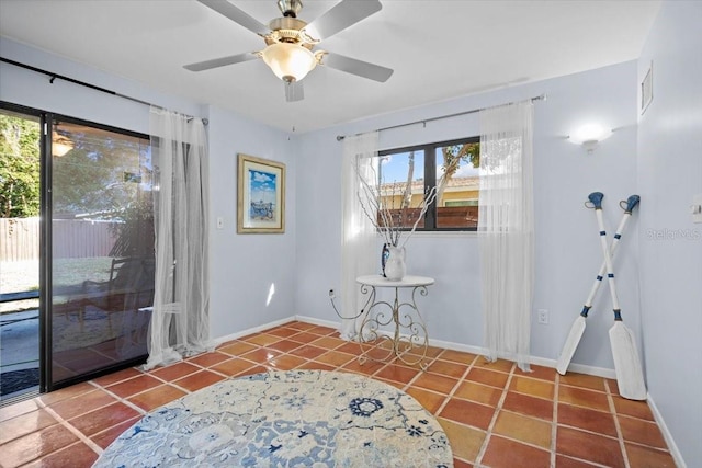 living area with tile patterned flooring and ceiling fan