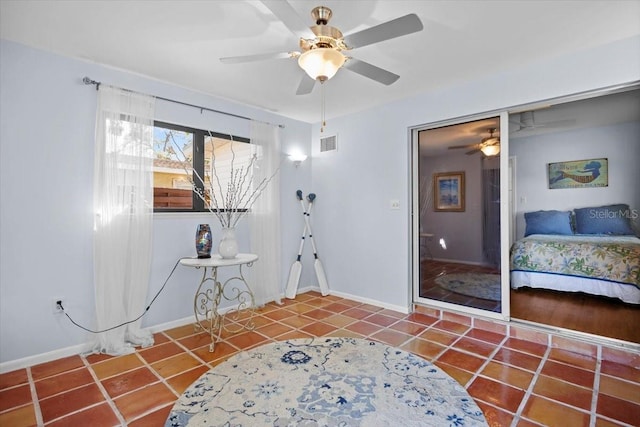 interior space with ceiling fan and tile patterned flooring