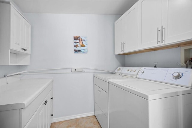 washroom with cabinets, independent washer and dryer, and light tile patterned floors