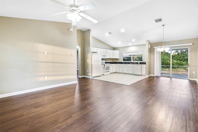 unfurnished living room with ceiling fan with notable chandelier, light hardwood / wood-style floors, and lofted ceiling