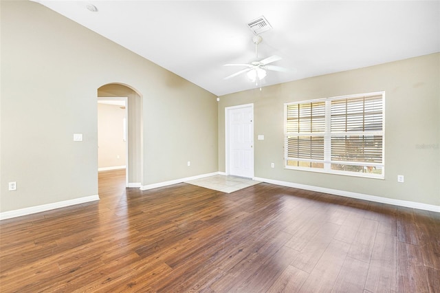 empty room with wood-type flooring, vaulted ceiling, and ceiling fan