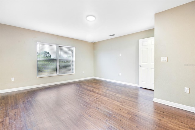 unfurnished room with hardwood / wood-style flooring