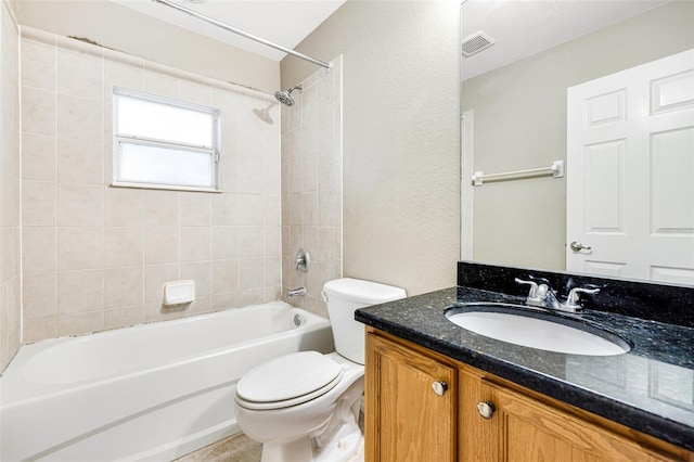 full bathroom with vanity, toilet, and tiled shower / bath