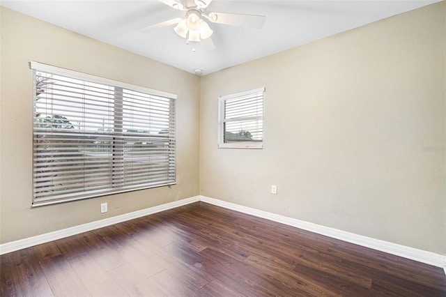 spare room featuring ceiling fan and dark wood-type flooring