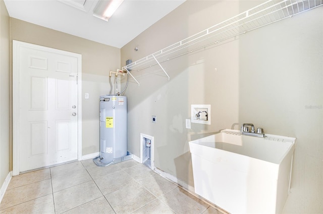 laundry area featuring electric dryer hookup, tile patterned floors, sink, washer hookup, and water heater