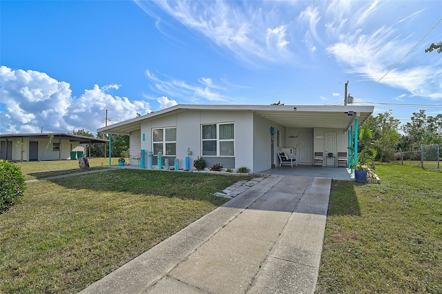 view of front of house with a front lawn and a carport