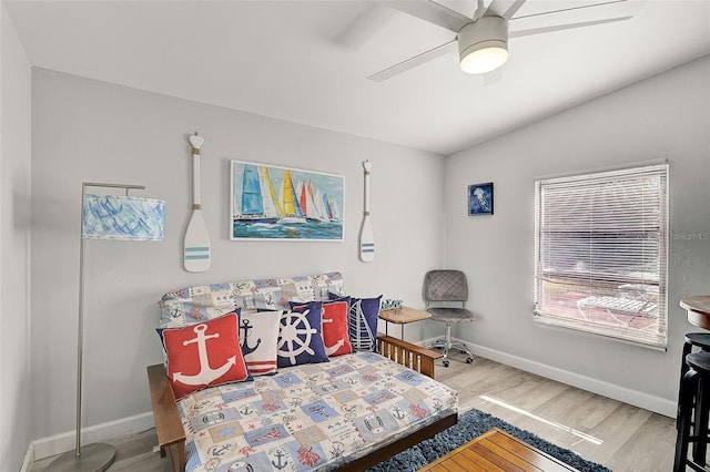 bedroom featuring ceiling fan, lofted ceiling, and hardwood / wood-style flooring