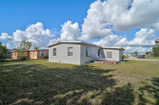 rear view of property featuring a yard